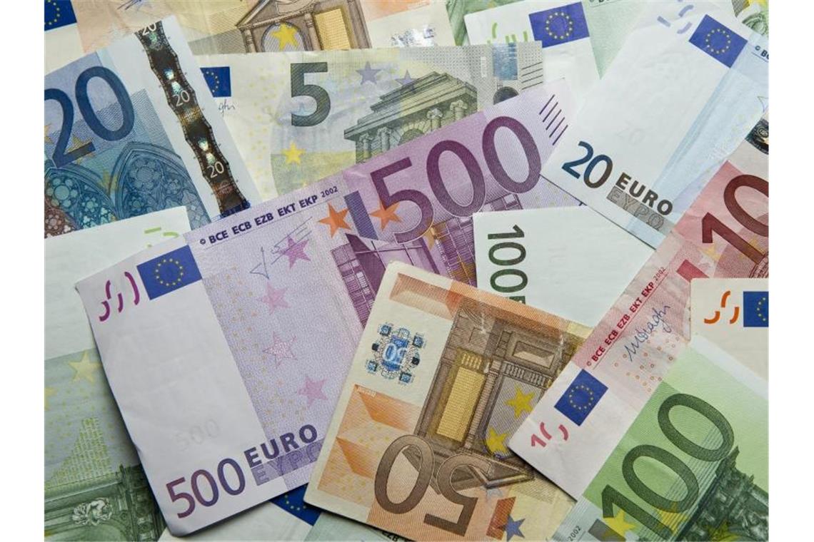 Zahlreiche Euro-Banknoten liegen auf einem Haufen. Foto: Daniel Reinhardt/dpa/Symbolbild