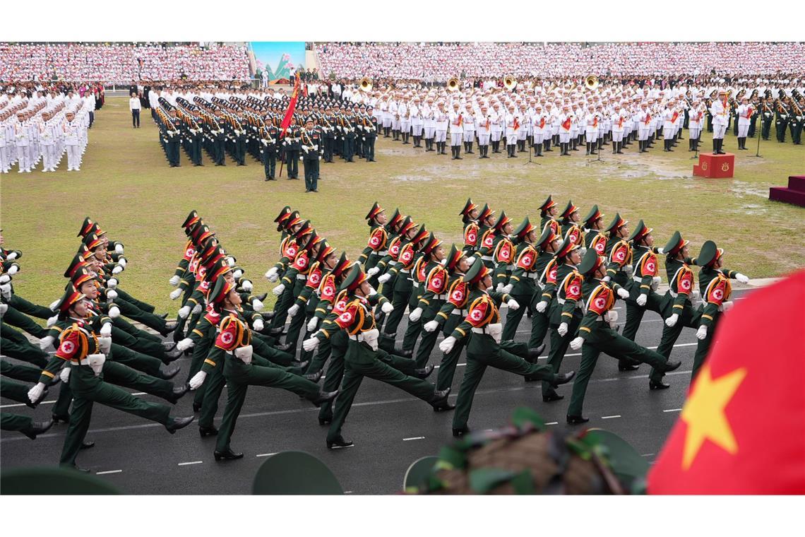 Zahlreiche Soldaten marschieren über ein Gelände in Dien Bien Phu. Mit der Parade feiert Vietnam den 70. Jahrestag des Sieges über die französische Armee und damit das Ende der Kolonialherrschaft.