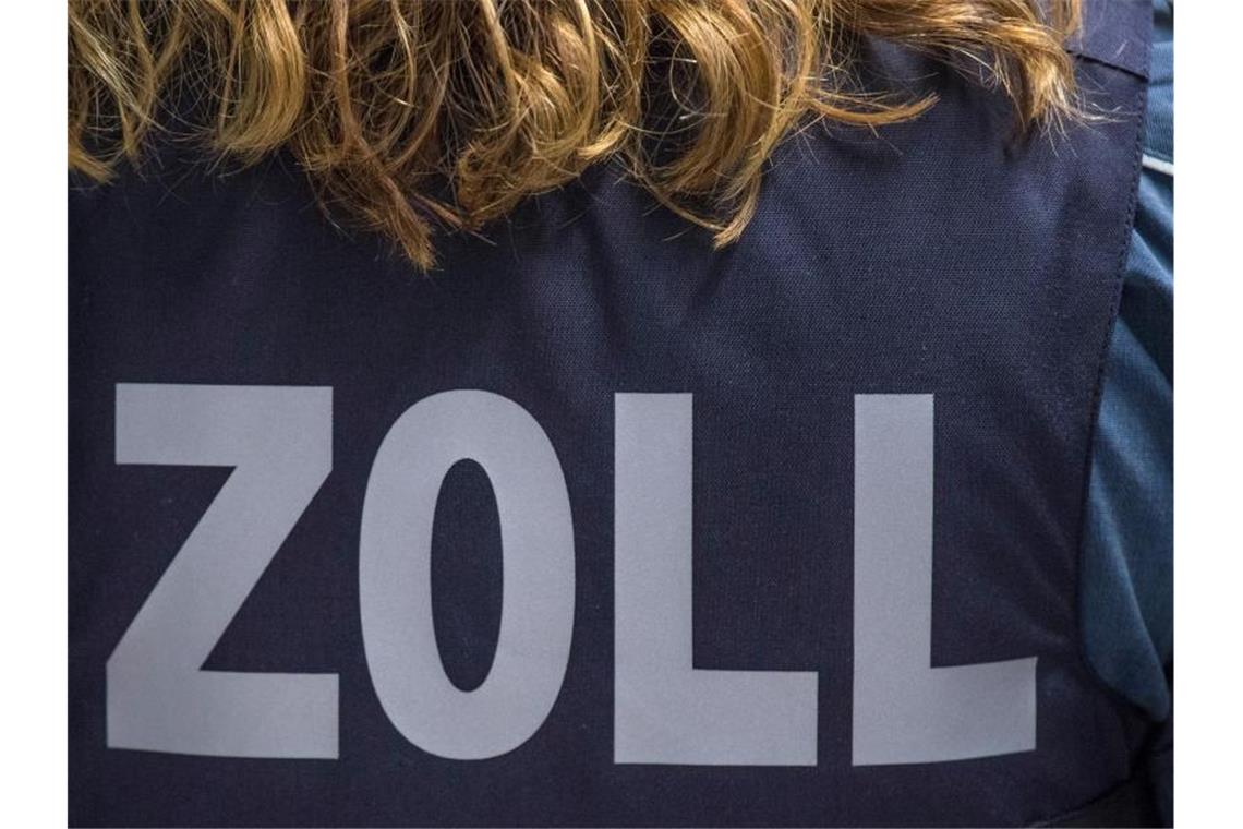 „Zoll“ steht auf der ballistischen Schutzweste einer Zöllnerin. Foto: Boris Roessler/dpa/Archivbild