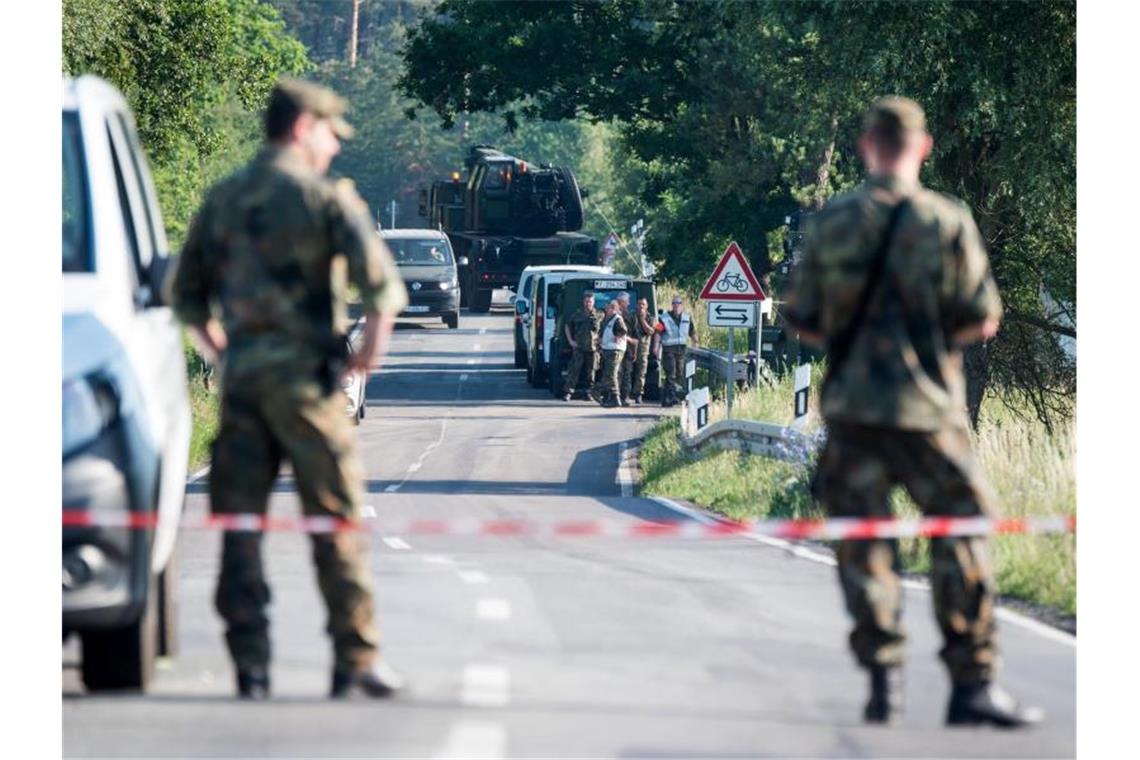 Zwei Soldaten stehen an einer Straßensperre in der Nähe eines Waldgebiets bei Nossentin, wo einer der beiden Eurofighter abgestürzt ist. Foto: Daniel Bockwoldt